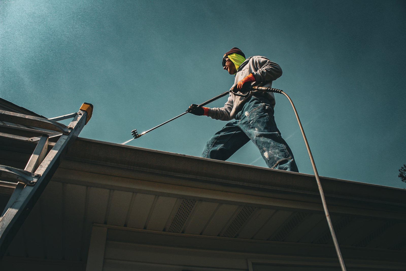 Dominic on the roofline clearing gutters in North Jersey